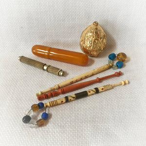 Group of Sewing Items: Bone Lace Bobbins, Bakelite Needle Case, Gold Tone Walnut Sewing Kit