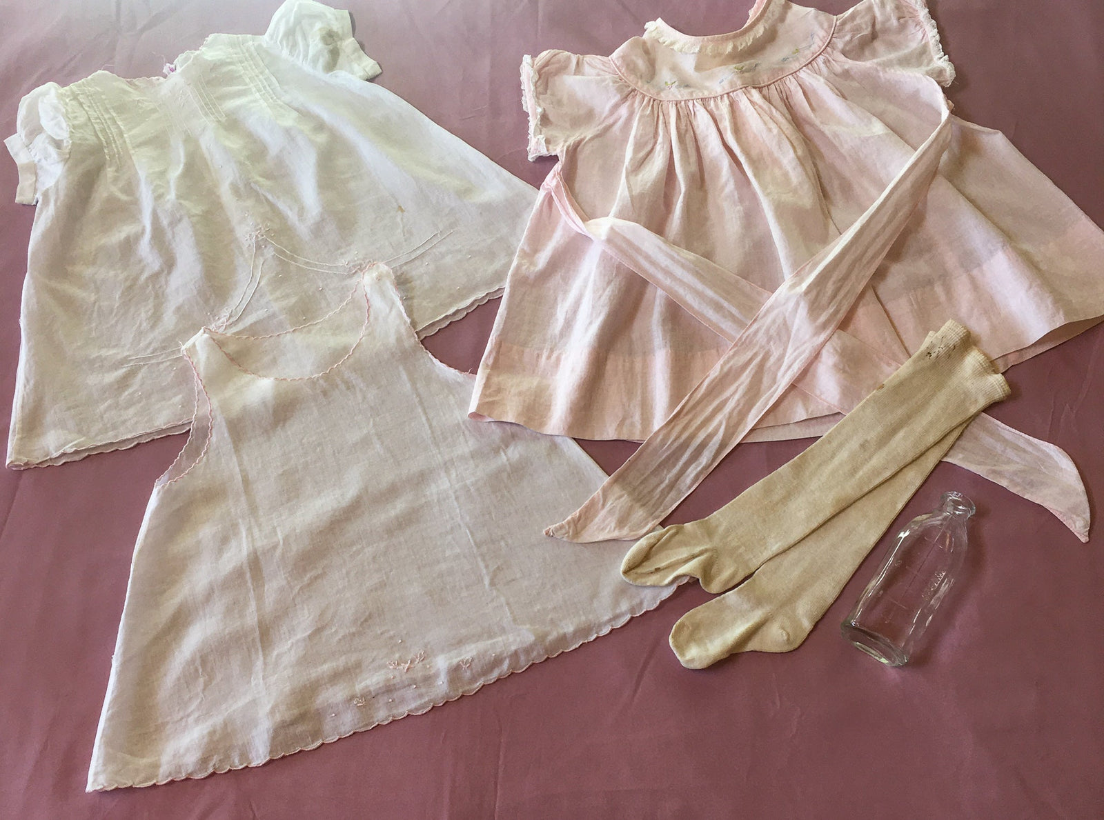 Vintage Baby Bundle, 2 Mid Century Cotton Dresses with 1 Slip, White Stockings, 1940’s 4 Oz. Bottle