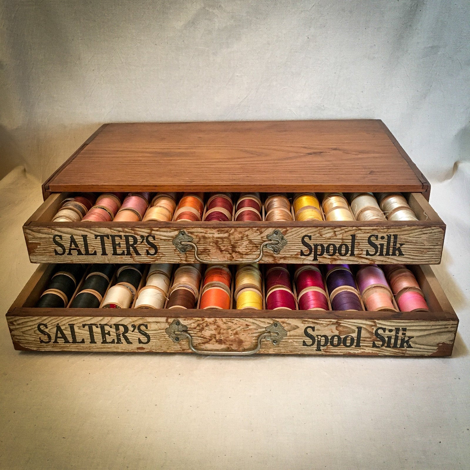 Early 1900’s Salter’s Spool Silk Cabinet with 143 Wooden Spools of Silk and Thread